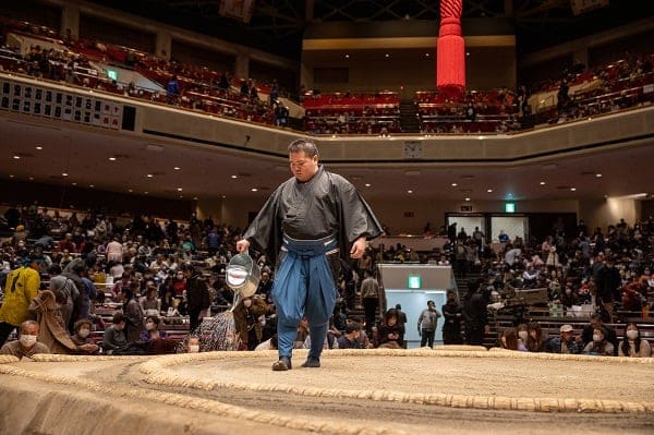 Sumo Wrestler put some water on stage