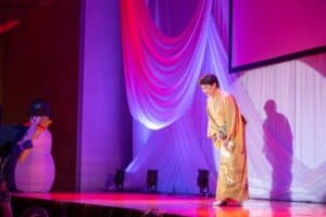 Woman on stage bowing