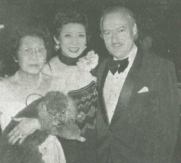 Chiye Hachisuka, chairman of the JAWS Black and White Ball, poses happily with pop singer Pinky (Yoko Kon) and John Read, general manager of the Rolex Watch Centre.