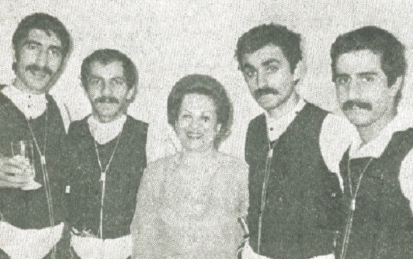 Nilufer Eyiceoglu surrounded by Turkish dancers.