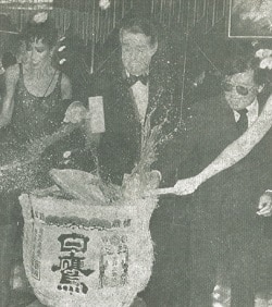 World-renown designer Halston, one of the fave mannequins Pat Cleveland and Vogue cameraman Hiro Wakabayashi bust up a barrel of sake at the Halston Charity Evening at the Samba.