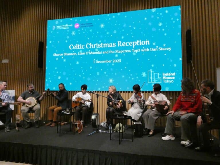 A group of Irish and Japanese musicians performing on stage at Ireland House Tokyo for the 2025 Celtic Christmas Reception.