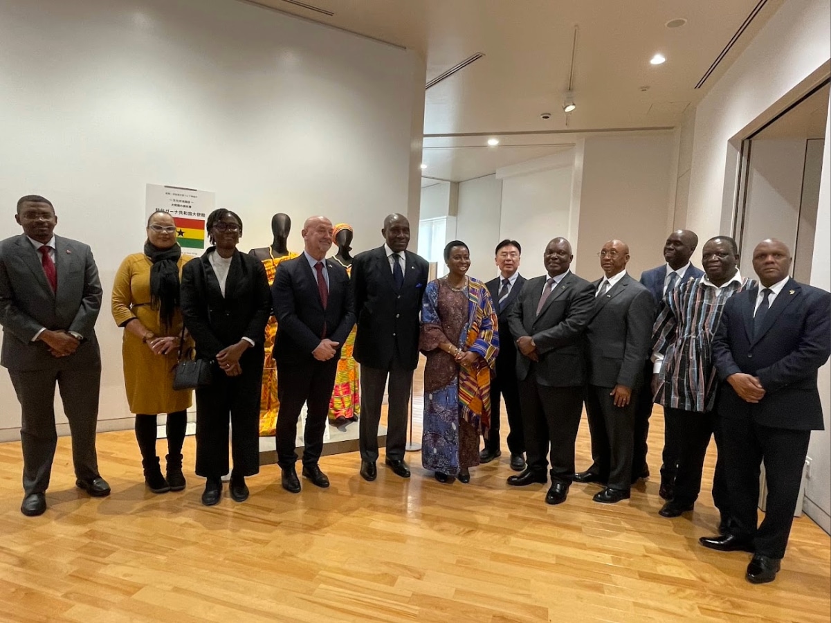 Group photo of distinguished guests, including African ambassadors and students, at the Ghana Embassy Art Exhibition opening.