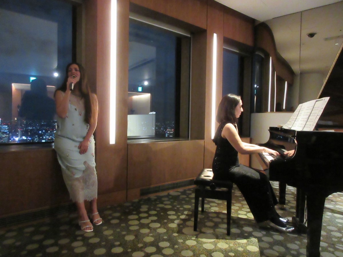 Ada Athanasopoulou performing a Greek-Japanese musical tribute with a pianist in Japan.