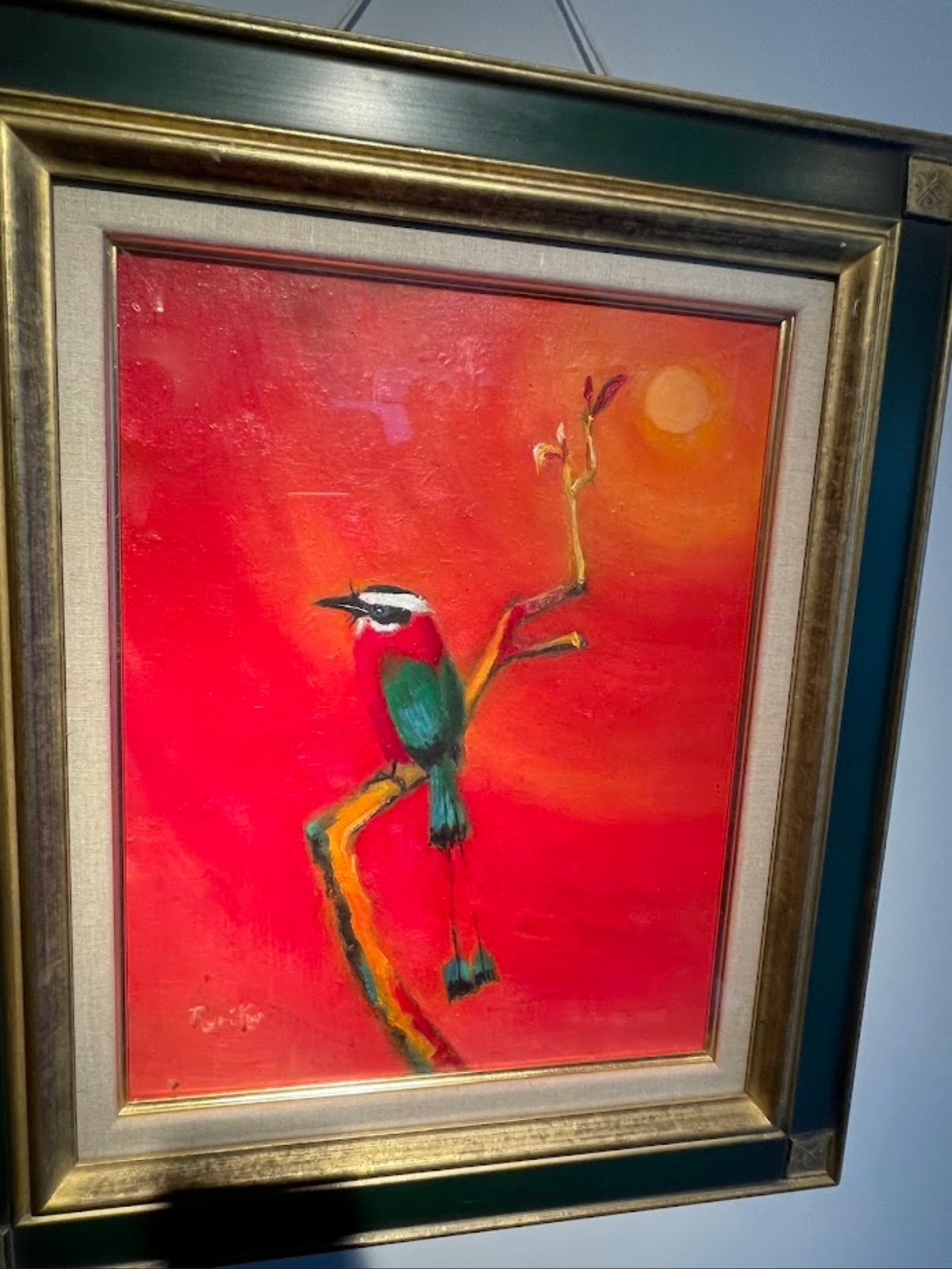 Ruriko Escobar’s symbolic painting of the Trogoz, the national bird of El Salvador, featuring vibrant red and green plumage.