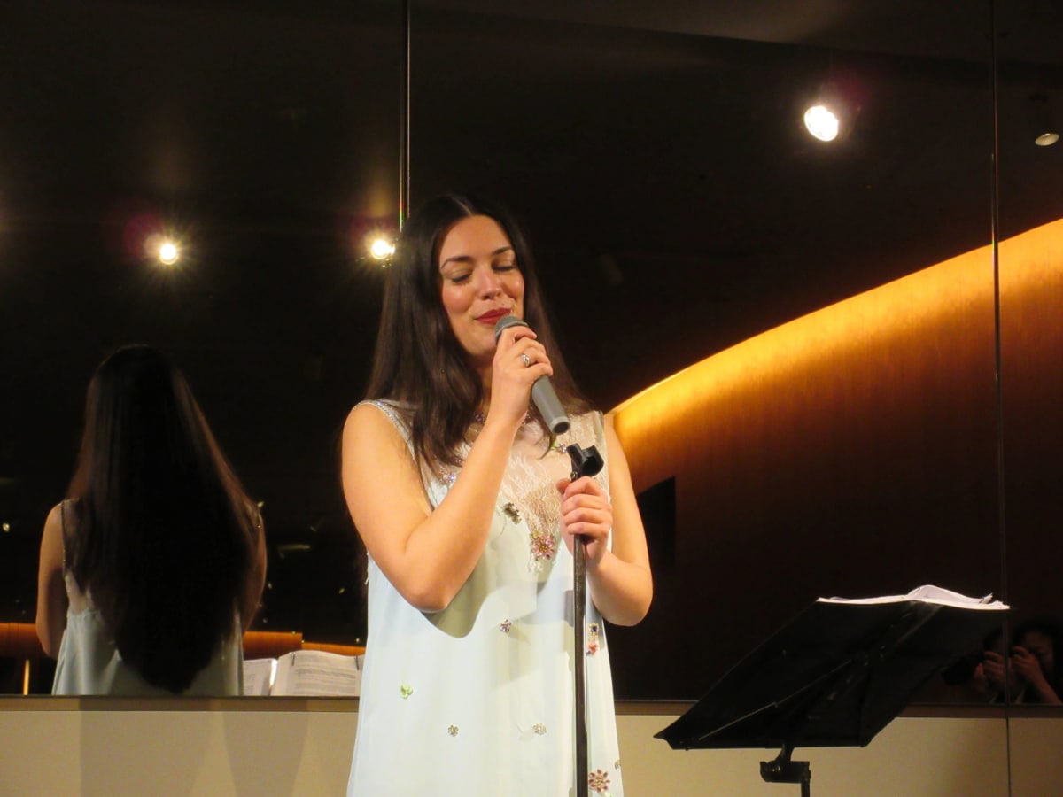 Greek soprano Ada Athanasopoulou singing at a cultural event in Tokyo.