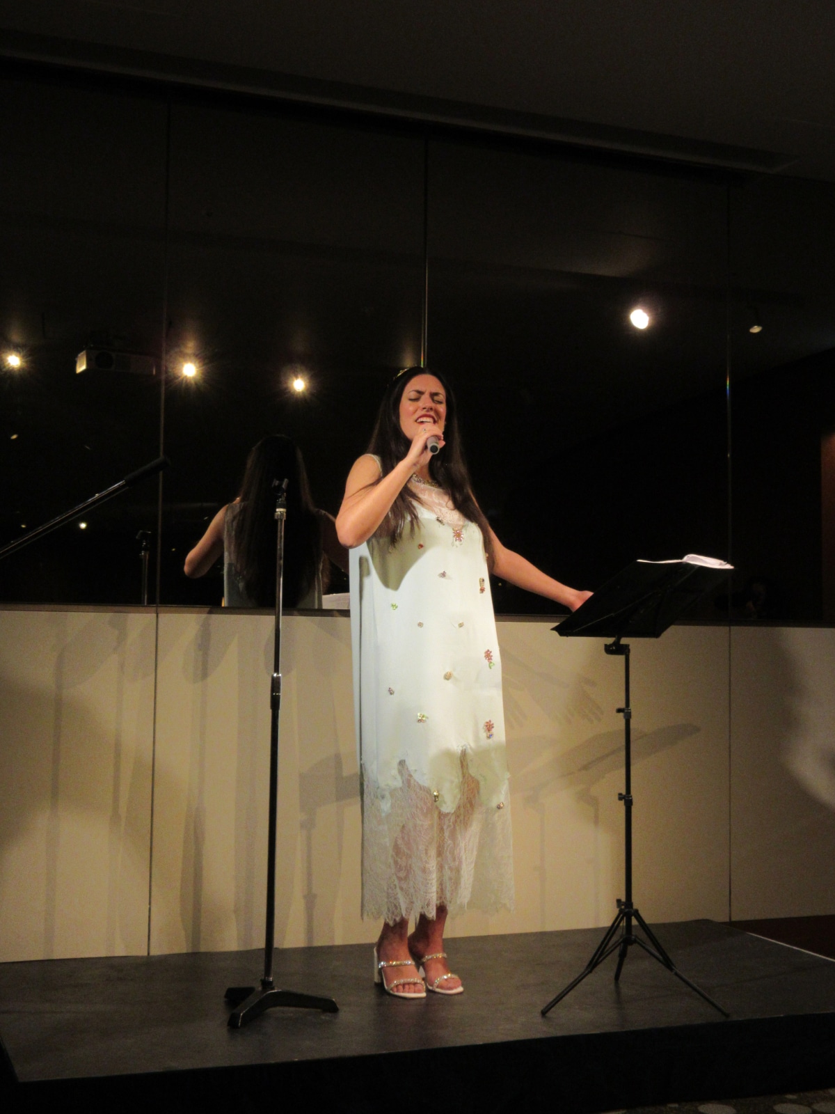 Greek soprano Ada Athanasopoulou singing at a cultural event in Tokyo.