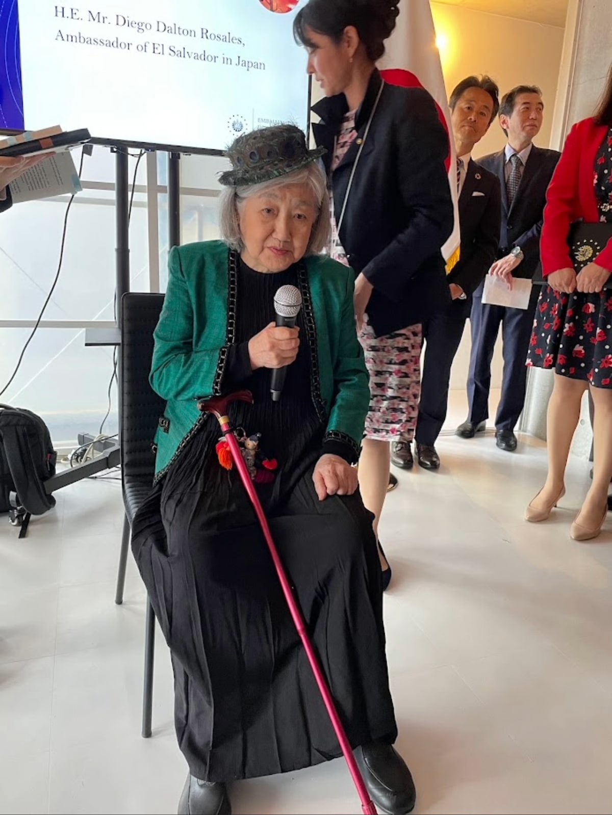 A close-up of Ruriko Escobar speaking at the exhibition, reflecting on her experiences living through historically turbulent times in El Salvador.