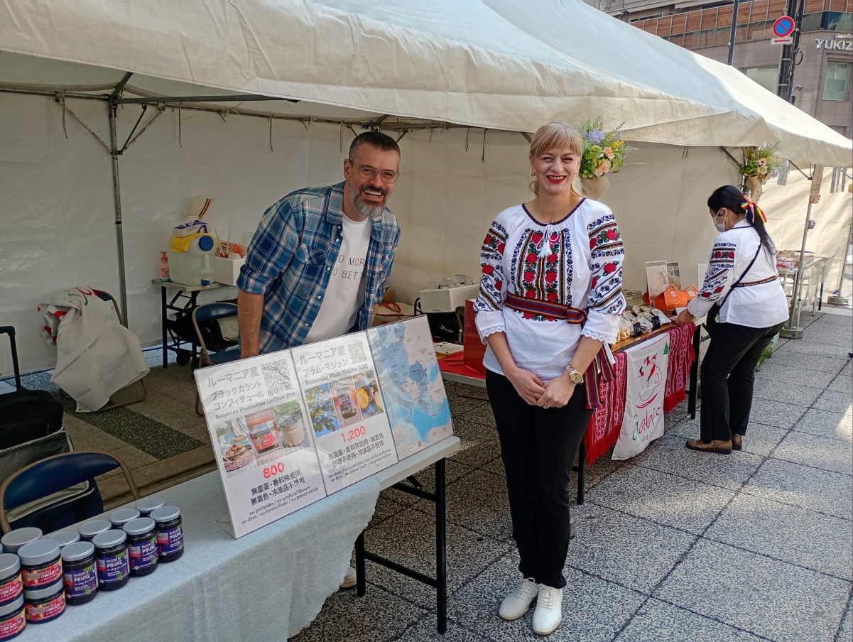 Volunteers at the Romanian Embassy booth sharing information about Romanian culture and products with visitors.