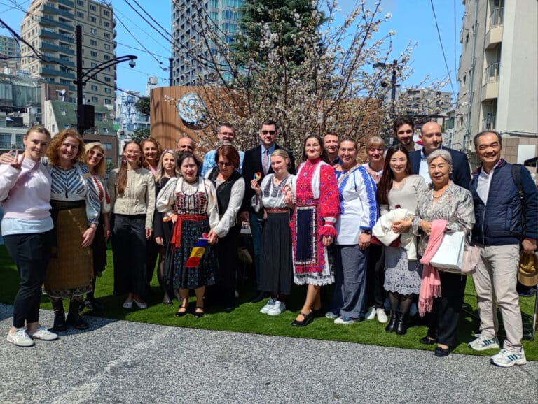 Members of the Romanian community in Japan and embassy staff posing in traditional clothing at the Spring Rokusan Hiroba Festa in Minato Ward.