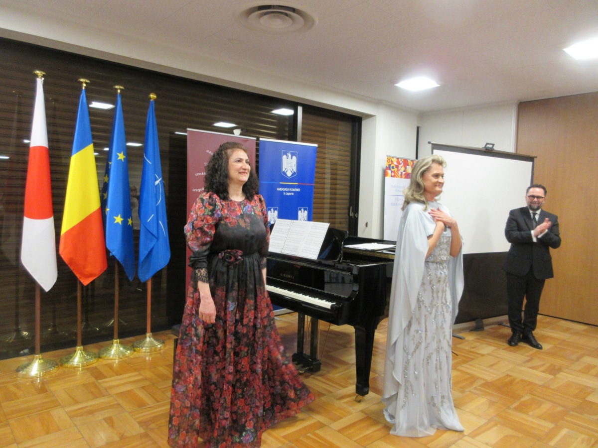 Soprano Iulia Isaev and pianist Liana Mareș taking a bow after their gala concert at the Romanian Embassy in Tokyo, with General Director Daniel Jinga applauding in the background