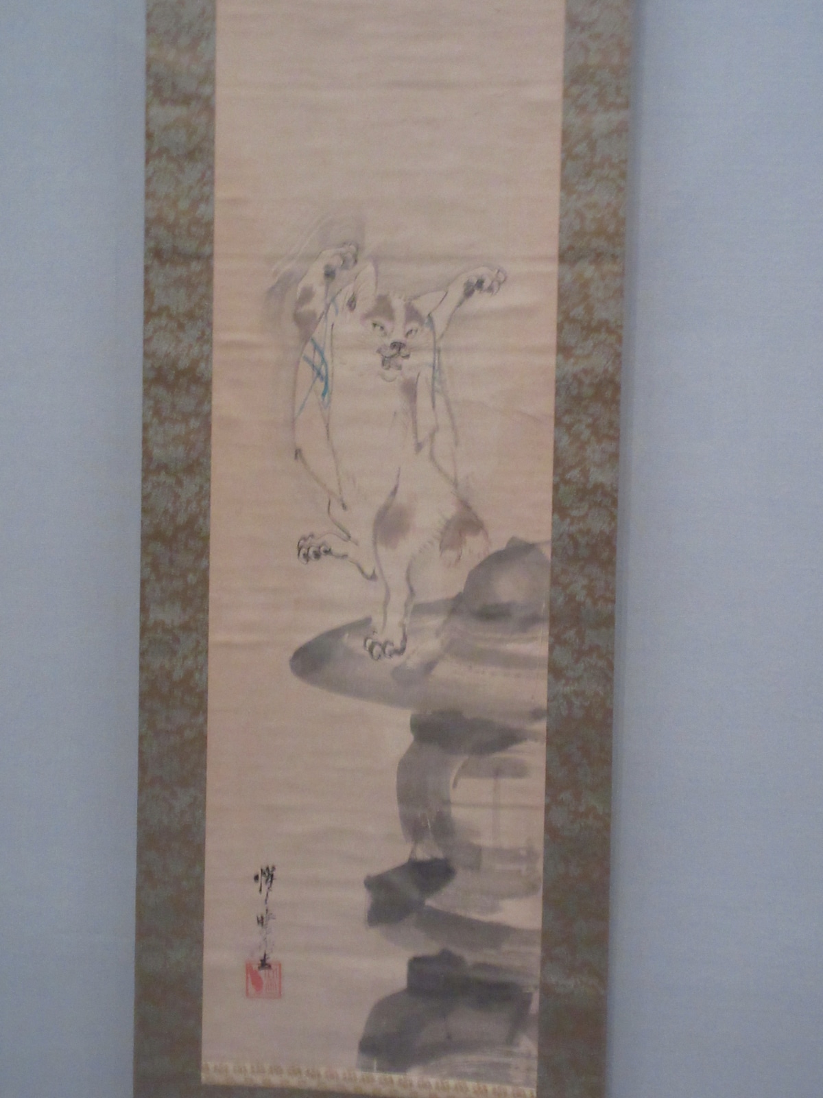 Kawanabe Kyōsai ink scroll of an expressive cat rearing up on a rock, from the Beasts chapter of the Israel Goldman Collection exhibition