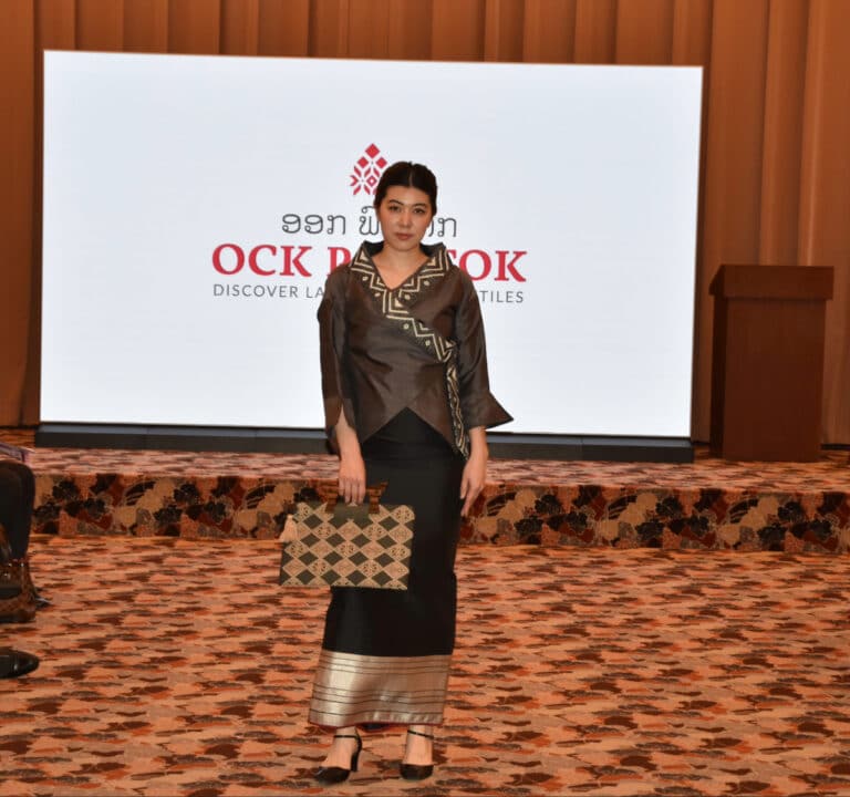 Model wearing modern Laotian traditional textile design by Ock Pop Tok at the Lao Fashion and Culture Festival in Japan