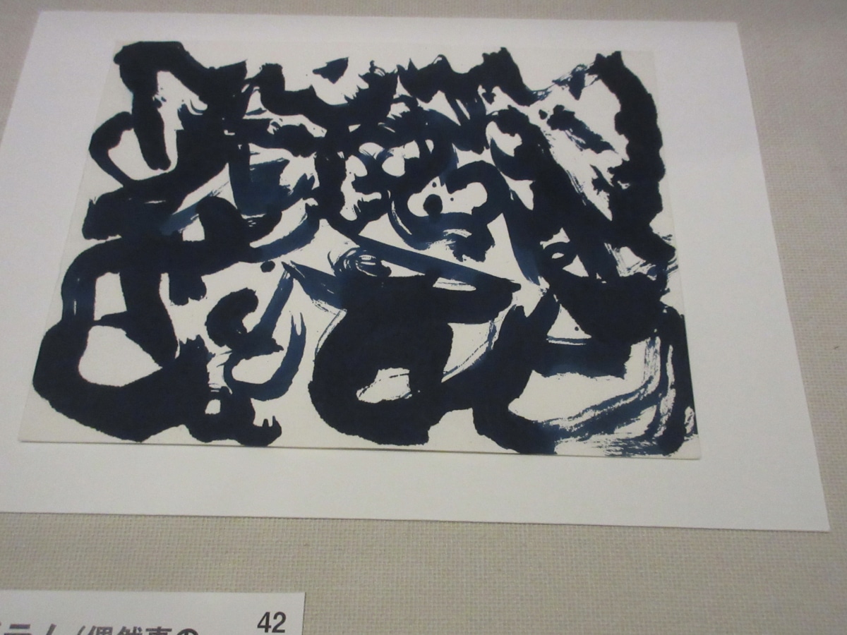 Abstract calligraphic artwork resembling a logogram by Christian Dotremont, displayed at the Belgium-Japan exchange exhibition