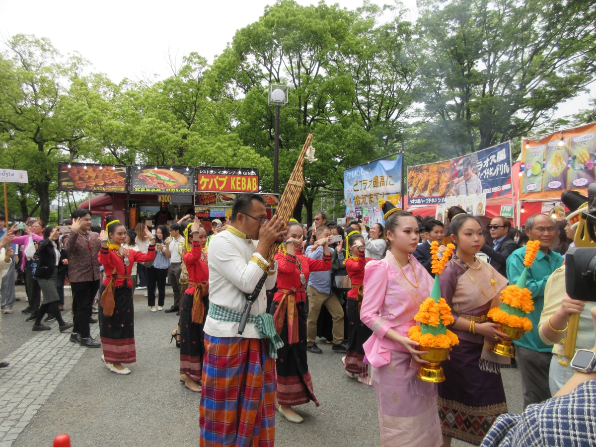 Lao traditional dancers and musicians in colorful attire performing at the Laos Festival 2026 in Yoyogi Park, Tokyo