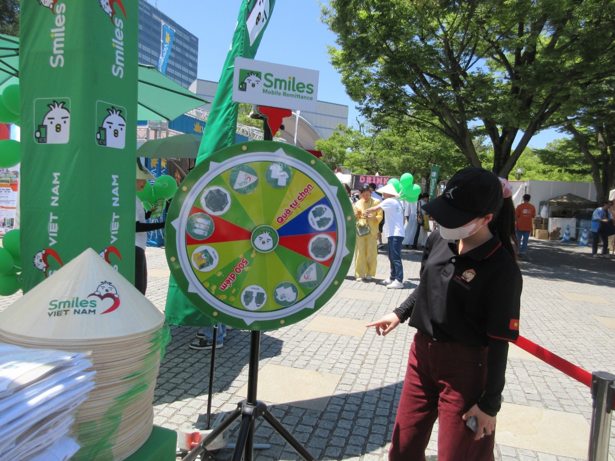 Smiles Vietnam booth with interactive prize wheel and Vietnamese conical hats at the Vietnam Festival 2026 in Yoyogi Park