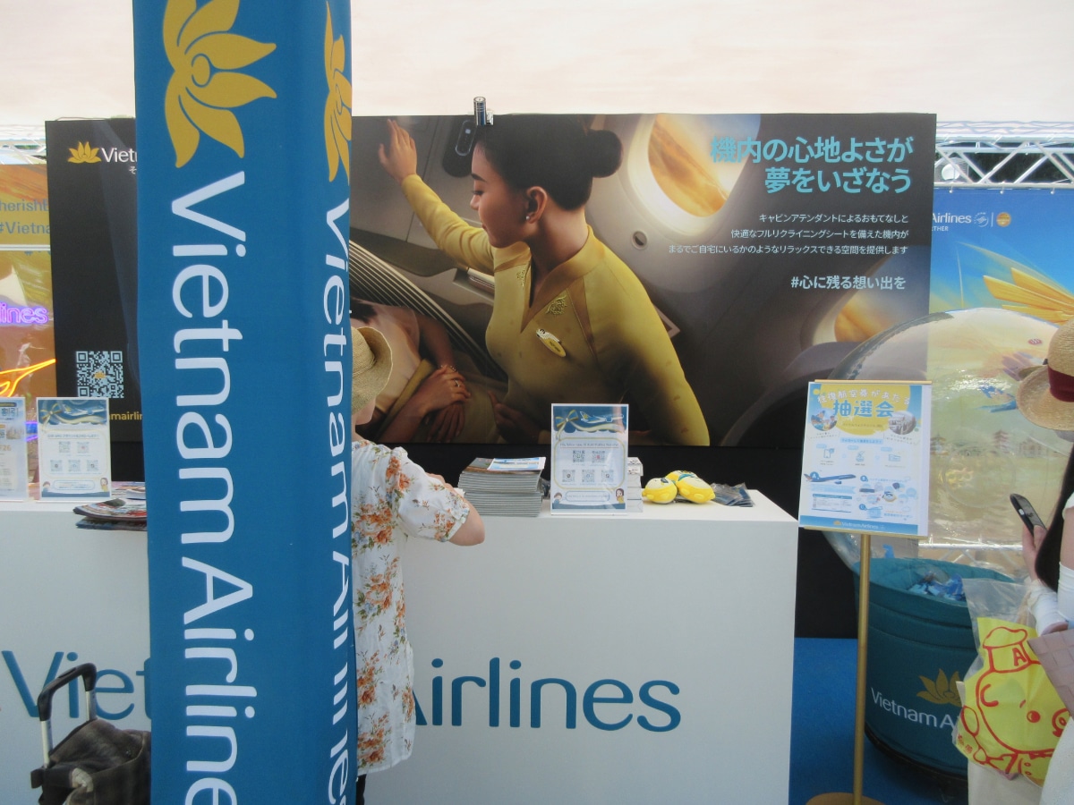 Vietnam Airlines booth with promotional materials and cabin crew imagery at the Vietnam Festival 2026 in Yoyogi Park, Tokyo