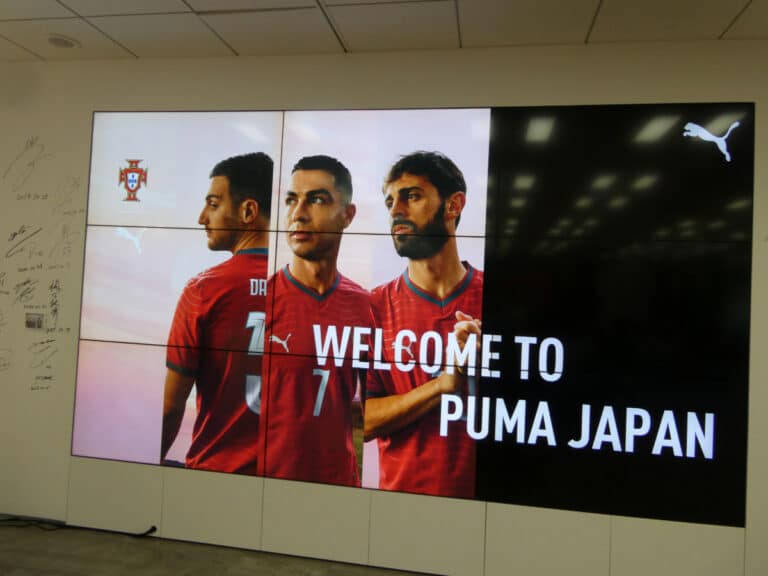 Welcome screen at PUMA Japan headquarters featuring Portugal national team players before the live viewing event