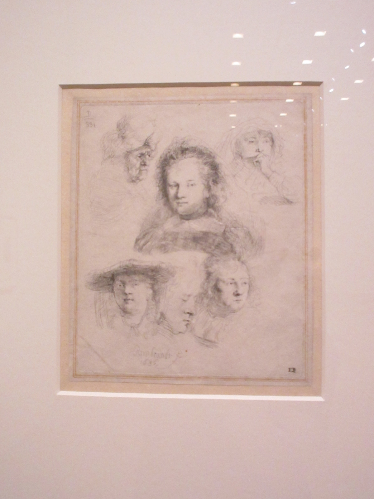 Printed etching from Rembrandt's copper plate showing multiple head studies
