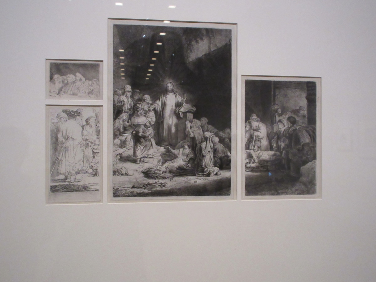 Gallery wall displaying several Rembrandt religious-themed etchings