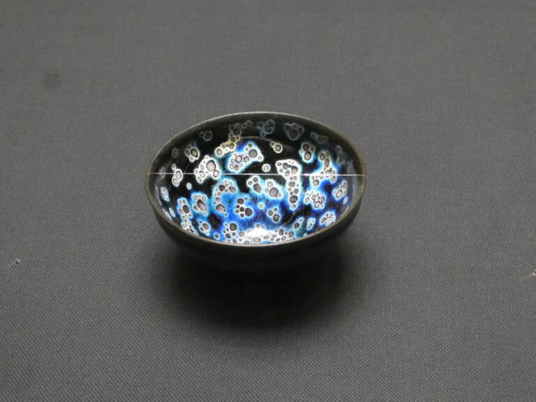 Yohen tenmoku tea bowl with blue and silver spots on black glaze, shown at the Kawai Kanjiro exhibition
