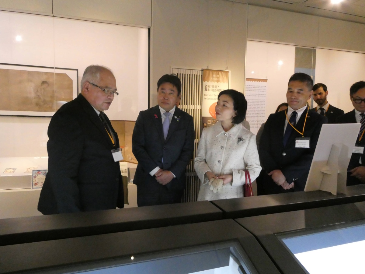 Princess Akiko and accompanying officials examine a diplomatic document display at the Atsugi exhibition