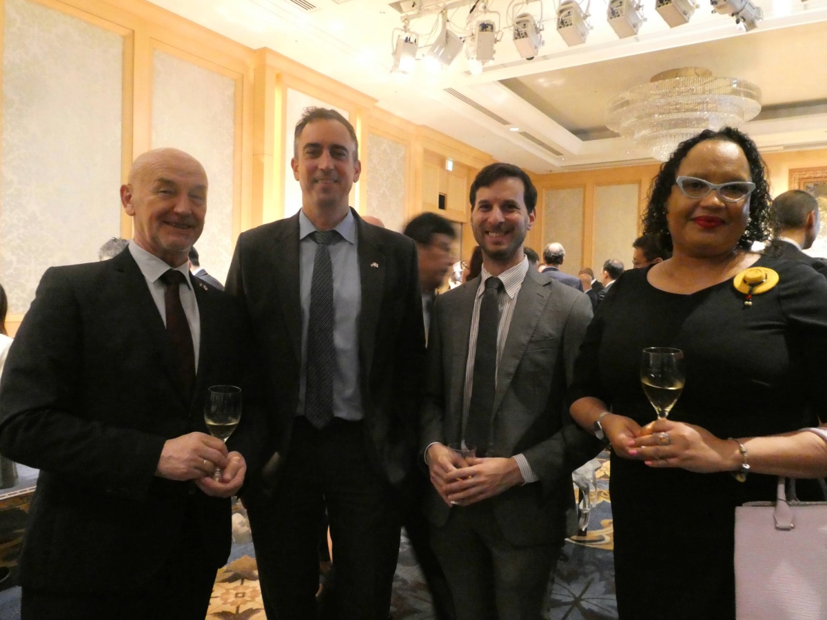 Four guests hold wine glasses and smile at the Armenia 35th Independence Anniversary reception