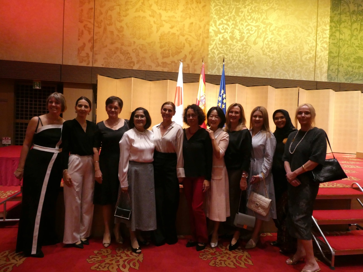Group of guests posing in front of the Japanese, Spanish and European Union flags at the Spain National Day reception in Japan