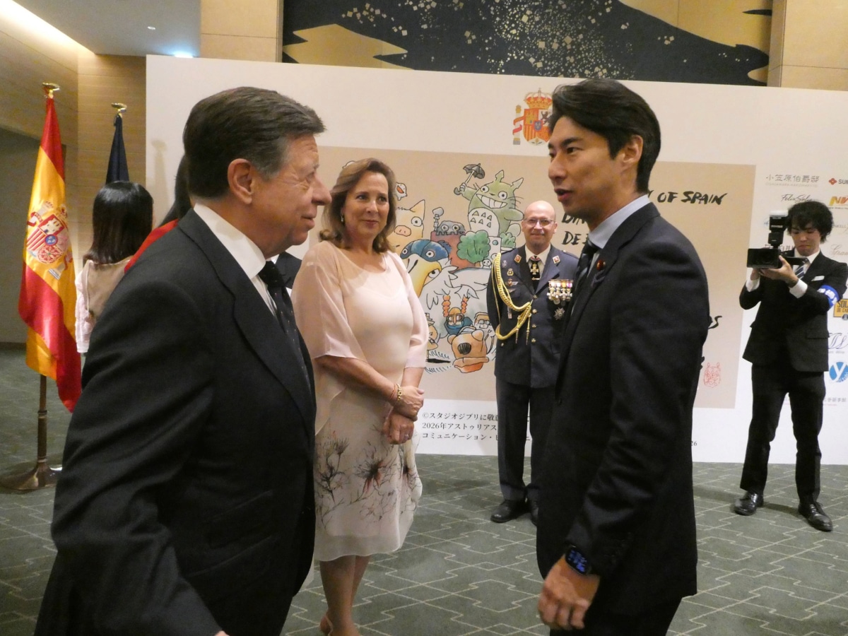 Guests chatting in front of the Studio Ghibli artwork and Spanish flag at the entrance of the Spain National Day reception in Japan