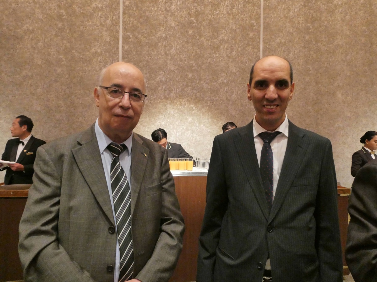 Two men in suits posing at the Tunisia-Japan diplomatic anniversary reception in Tokyo