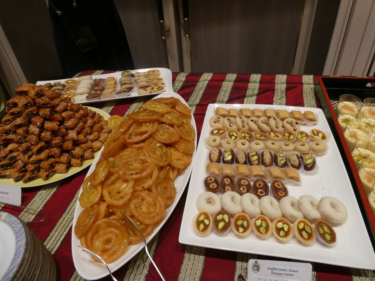 Platters of Tunisian sweets and pastries including stuffed dates and zlabia on the reception buffet